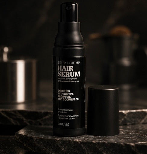 Black hair serum bottle with label on a dark background