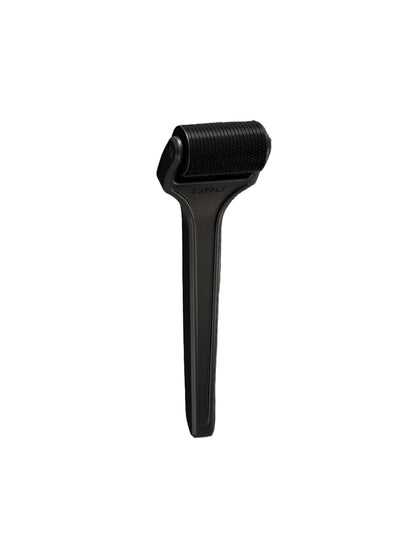 Black skin care tool on a white background