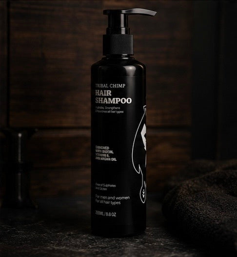 Black bottle of Tribal Chimp hair shampoo on a dark background