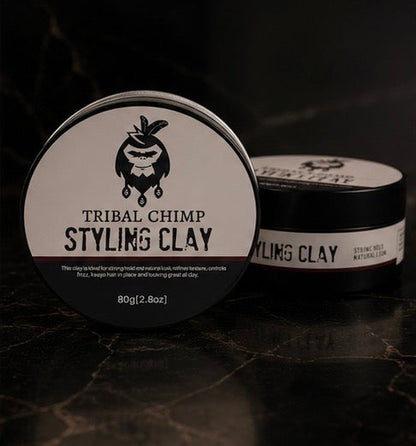 Tribal Chimp Styling Clay container on a dark textured background