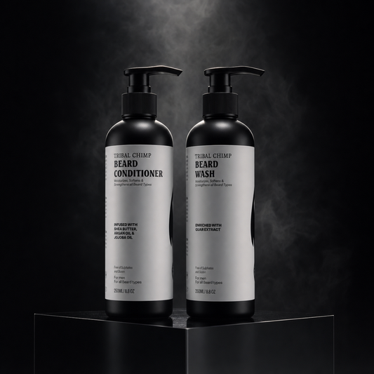 Two bottles of 'Tropical Chimp' beard care products on a dark background